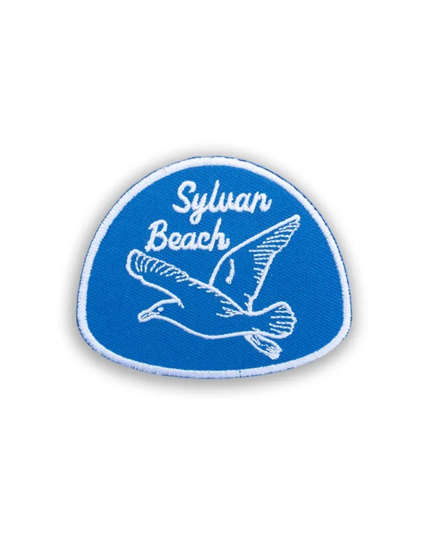 Sylvan Beach Embroidered Patch in blue and white featuring a flying gull inspired by Oneida Lake.